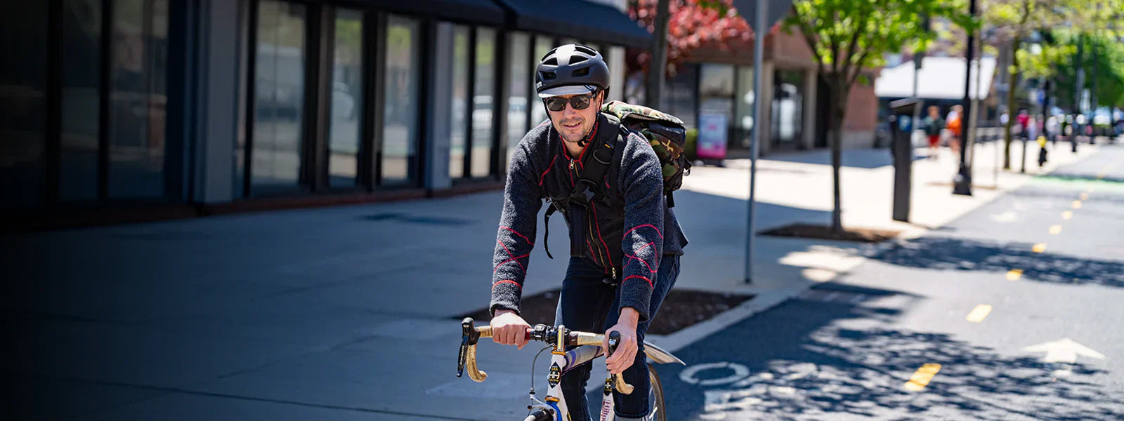 man wearing bern allston bike helmet commuting in city