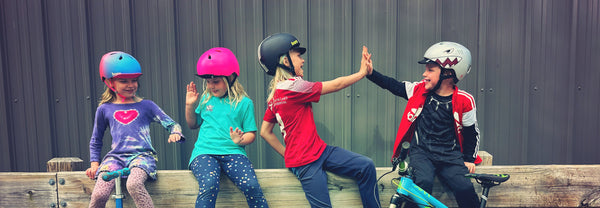 group of kids wearing bern nino and nina bike helmets