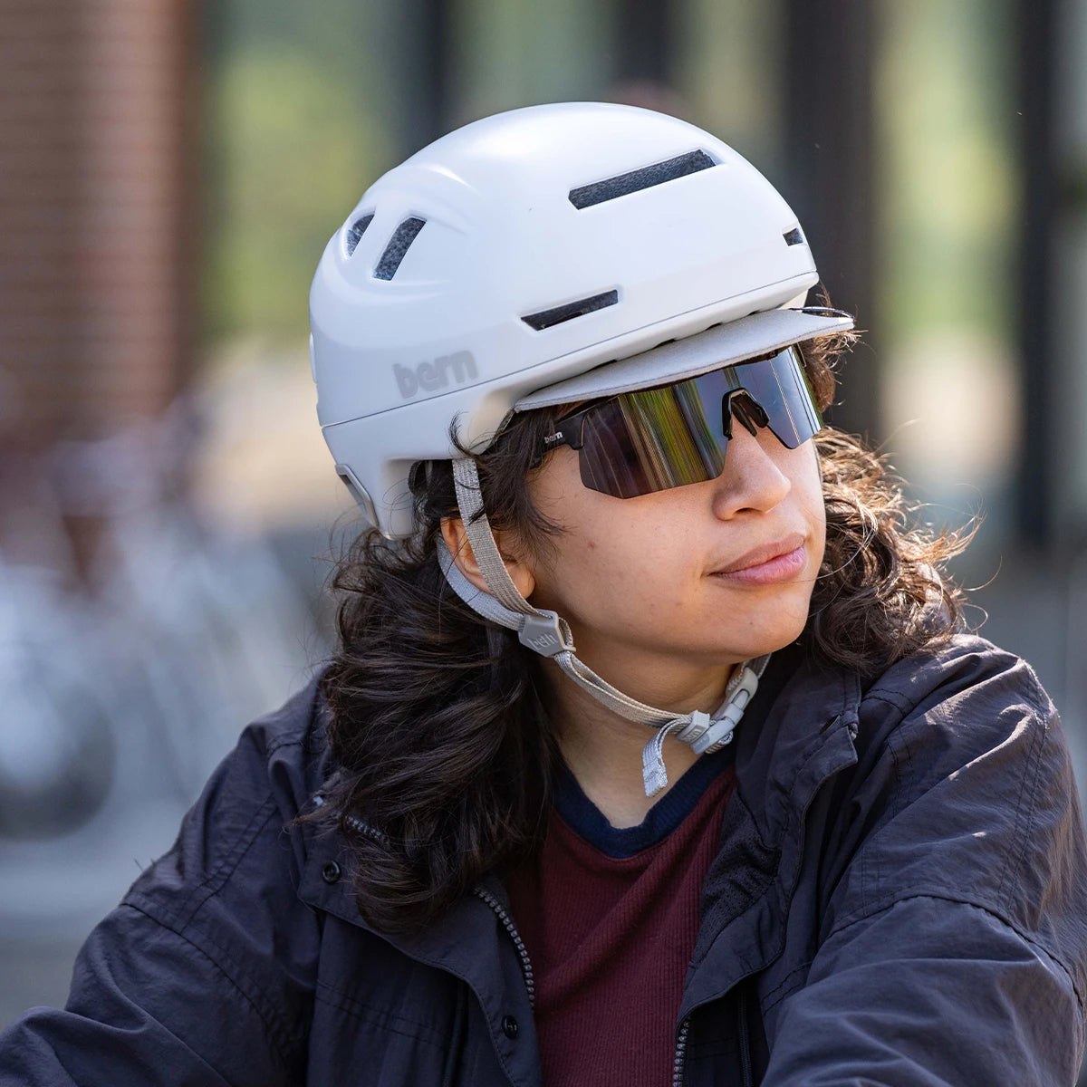 Person wearing a Bern Hudson matte white helmet and bern Blades sunglasses.