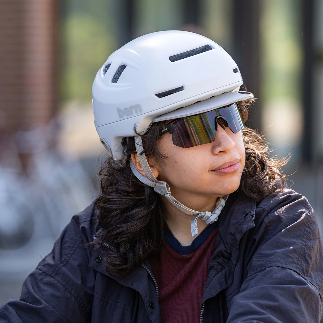 Person wearing a Bern Hudson matte white helmet and bern Blades sunglasses.