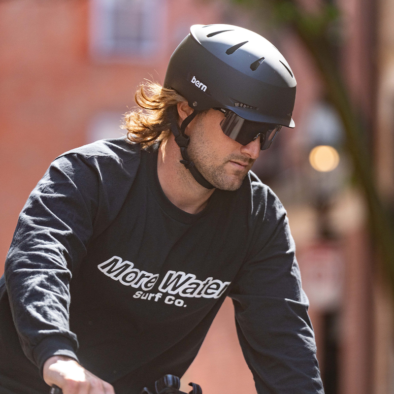man riding bicycle wearing hendrix helmet and bern blades sunglasses