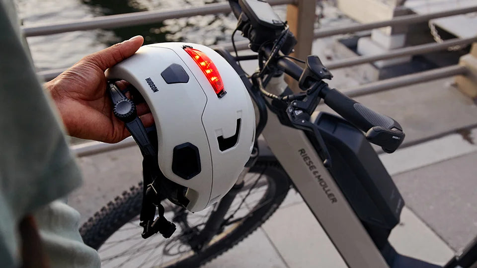 bike rider holding Bern Hudson e-bike helmet