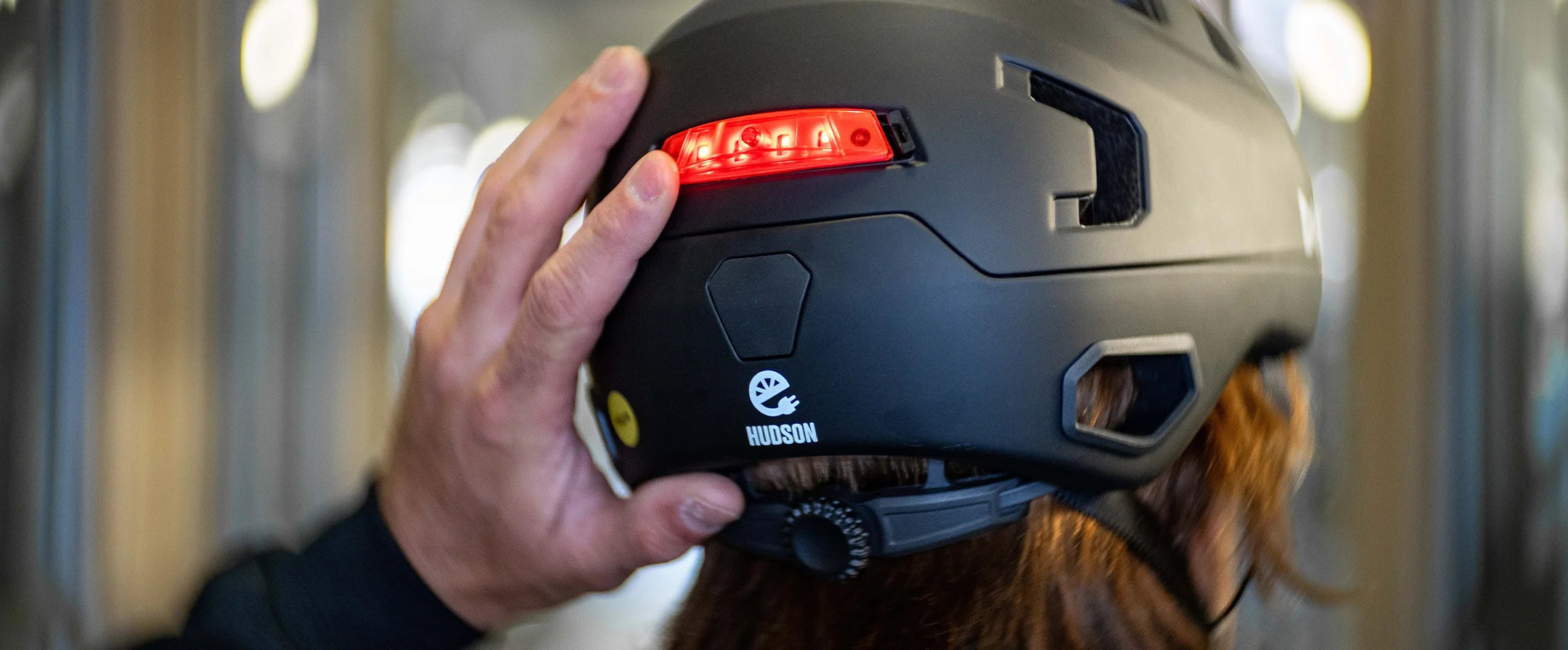 Close up of Bern Hudson Matte black E-bike helmet showing it's click-mount light and NTA 8776 logo.