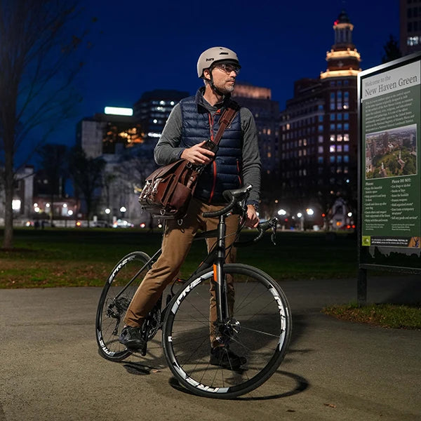 Man wearing Brentwood 2.0 riding a bike in Boston at night.