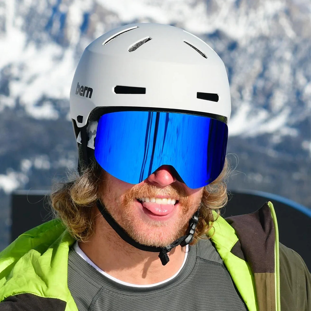 skier wearing bern macon 2.0 mips matte gray winter helmet with goggles