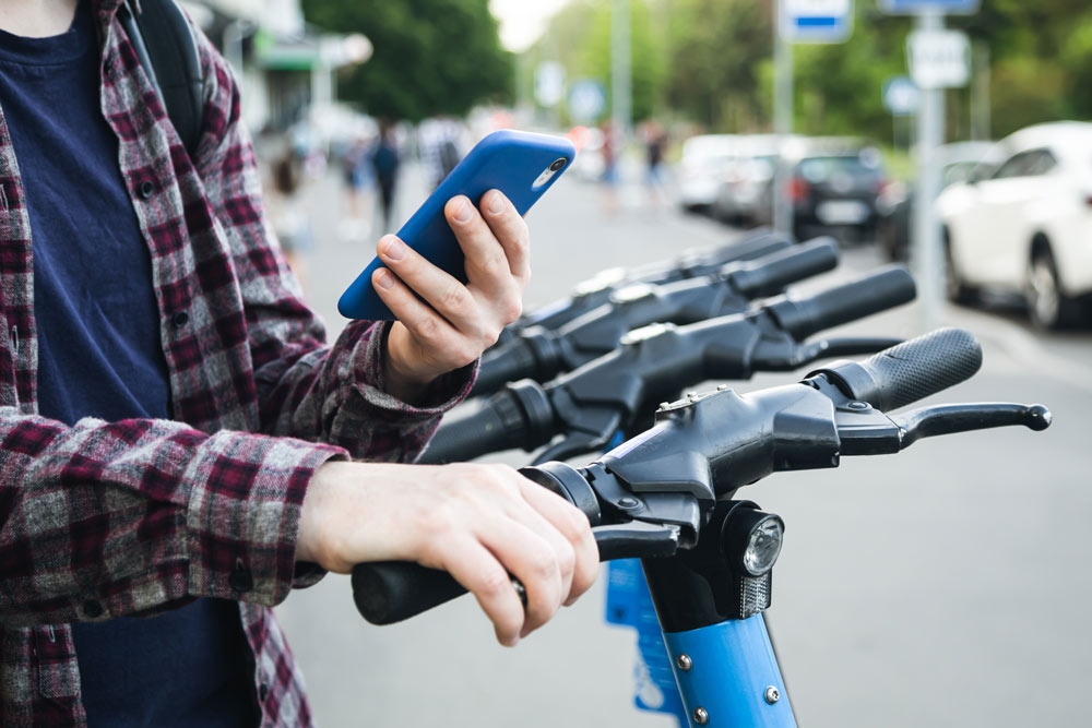 Rider unlocking shared e-bike using a mobility app